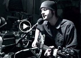 Tim singing and playing guitar.